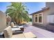 This back patio with seating, plants, and access to the pool makes it an outdoor oasis at 10520 Maystar Ln, Las Vegas, NV 89135