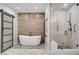 Luxurious bathroom showcasing a freestanding tub, a glass-enclosed shower, and decorative tile flooring at 10520 Maystar Ln, Las Vegas, NV 89135