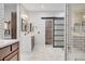 Modern bathroom with double vanity, subway tile, and a glass-enclosed shower at 10520 Maystar Ln, Las Vegas, NV 89135