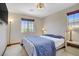 Bright bedroom features a plush carpet, neutral walls, and two windows at 10520 Maystar Ln, Las Vegas, NV 89135