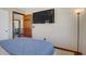 Bedroom with a large mounted tv, plush carpet, and neutral walls at 10520 Maystar Ln, Las Vegas, NV 89135