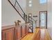 Bright foyer with hardwood floors, a staircase, and an elegant entry door at 10520 Maystar Ln, Las Vegas, NV 89135