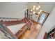Grand foyer featuring hardwood floors, a modern staircase, and an elegant chandelier at 10520 Maystar Ln, Las Vegas, NV 89135