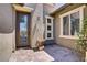 Inviting front entrance with a decorative glass door and beautiful stone accents at 10520 Maystar Ln, Las Vegas, NV 89135