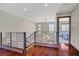 Bright hallway showcasing hardwood floors, a staircase with modern railings, and natural light at 10520 Maystar Ln, Las Vegas, NV 89135
