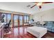 Bright living room features wood floors, ceiling fan, and door to the balcony at 10520 Maystar Ln, Las Vegas, NV 89135