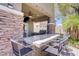 A covered back patio with a grill and an outdoor bar creates an entertainment area at 10520 Maystar Ln, Las Vegas, NV 89135