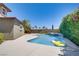 Inviting backyard pool with sunny deck space, mature landscaping, and a playful inflatable raft at 10520 Maystar Ln, Las Vegas, NV 89135