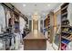 Spacious walk-in closet with custom shelving, a chandelier, and ample storage space at 10520 Maystar Ln, Las Vegas, NV 89135