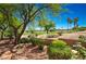 Back yard with golf course views and desert landscaping at 10573 Bambola Pl, Las Vegas, NV 89135