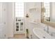 Bathroom with pedestal sink, custom mirror, and a tile floor is well decorated and efficiently designed at 10573 Bambola Pl, Las Vegas, NV 89135