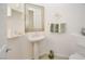 Bathroom with pedestal sink, custom mirror, and a tile floor is well decorated and efficiently designed at 10573 Bambola Pl, Las Vegas, NV 89135
