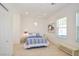 Bright bedroom features two windows, wood floors, and accent art at 10573 Bambola Pl, Las Vegas, NV 89135