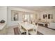 An open-concept dining room area with neutral decor including access and views into the living room at 10573 Bambola Pl, Las Vegas, NV 89135