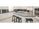 Modern kitchen featuring granite countertops, stainless steel appliances, and a breakfast bar for casual dining at 10573 Bambola Pl, Las Vegas, NV 89135