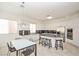 Bright and spacious kitchen featuring granite countertops, stainless steel appliances, and a center island with bar seating at 10573 Bambola Pl, Las Vegas, NV 89135