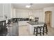 Bright kitchen features stainless steel appliances, granite countertops, a tile floor, and a breakfast bar with seating at 10573 Bambola Pl, Las Vegas, NV 89135