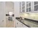 Pantry area with cabinets and granite countertop located off the kitchen provides great storage space and is well lit at 10573 Bambola Pl, Las Vegas, NV 89135