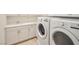 Laundry room with updated washer, dryer, cabinetry and sink at 10573 Bambola Pl, Las Vegas, NV 89135