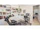 Office with a large built-in bookcase, a desk and chair, and a comfortable reading area is great for working at home at 10573 Bambola Pl, Las Vegas, NV 89135