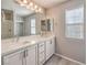 Bathroom featuring a double vanity, large mirror, and shower at 1201 Seaboard Ct, Henderson, NV 89002