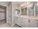 Bright bathroom featuring a double vanity, undermount sinks, and a large mirror at 1201 Seaboard Ct, Henderson, NV 89002