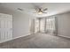 Open bedroom with neutral carpet, ceiling fan and a glass patio door at 1201 Seaboard Ct, Henderson, NV 89002