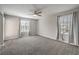 Large bedroom with neutral carpet, ceiling fan and two sunny windows at 1201 Seaboard Ct, Henderson, NV 89002