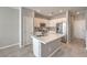 Bright kitchen features stainless appliances and island with sink and stone countertops at 1201 Seaboard Ct, Henderson, NV 89002