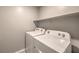 Bright laundry room features a Whirlpool washer and dryer, and convenient shelf storage at 1201 Seaboard Ct, Henderson, NV 89002