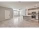 Open-concept living room featuring tile floors, abundant natural light, and access to a modern kitchen at 1201 Seaboard Ct, Henderson, NV 89002
