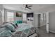 Spacious main bedroom with a ceiling fan, ensuite, and large windows for ample natural light at 140 Rolling Cove Ave, Henderson, NV 89011