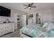 Spacious main bedroom featuring ceiling fan, ensuite, and views into the dining area and kitchen at 140 Rolling Cove Ave, Henderson, NV 89011