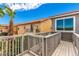 Second story deck showcasing sunny views, palm trees, and a railing system at 140 Rolling Cove Ave, Henderson, NV 89011