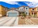 Charming two-story home with a two-car garage and desert landscaping with a beautiful, natural rock feature at 140 Rolling Cove Ave, Henderson, NV 89011