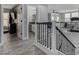 Bright hallway and loft featuring wood-look flooring, a staircase, and a versatile open space at 140 Rolling Cove Ave, Henderson, NV 89011