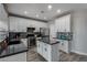 Modern kitchen features granite countertops, stainless steel appliances, and white cabinetry at 140 Rolling Cove Ave, Henderson, NV 89011
