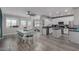 Open-concept kitchen boasts an island, stainless appliances, modern cabinetry, and adjoining dining area at 140 Rolling Cove Ave, Henderson, NV 89011