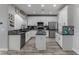 Well-equipped kitchen boasts granite countertops, stainless steel appliances, and white cabinetry at 140 Rolling Cove Ave, Henderson, NV 89011