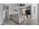 Spacious living room featuring a large sectional sofa, ceiling fan, neutral tones, and wood-look floors at 140 Rolling Cove Ave, Henderson, NV 89011