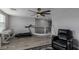 Open loft featuring wood floors, ceiling fan, and workout equipment, creating a dynamic space at 140 Rolling Cove Ave, Henderson, NV 89011