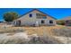 Backyard view of home with a balcony and desert landscaping in need of landscape upgrade at 1420 Logandale Dr, Logandale, NV 89021