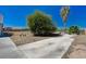 Large tree in the backyard on a sunny day near a long driveway at 1420 Logandale Dr, Logandale, NV 89021