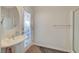 Bright bathroom features a pedestal sink, frosted window door, and a towel rack at 1420 Logandale Dr, Logandale, NV 89021