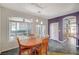 Dining area featuring a wood table with chairs, large window, and sliding glass door at 1420 Logandale Dr, Logandale, NV 89021