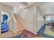 Hallway featuring a staircase leading upstairs and doorways leading to other rooms at 1420 Logandale Dr, Logandale, NV 89021