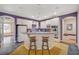 Bright open kitchen with a breakfast bar, white cabinets, and sleek appliances at 1420 Logandale Dr, Logandale, NV 89021