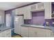 The kitchen is equipped with white appliances, sleek countertops, and ample cabinet space at 1420 Logandale Dr, Logandale, NV 89021