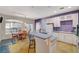Open kitchen with breakfast bar connects seamlessly to dining area, with white cabinets at 1420 Logandale Dr, Logandale, NV 89021