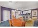 Open kitchen and dining area with bar seating, white cabinets, and modern appliances at 1420 Logandale Dr, Logandale, NV 89021